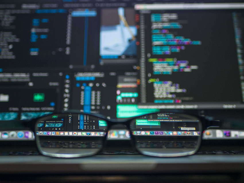 Multiple computer screens out of focus seen through a pair of eyeglasses